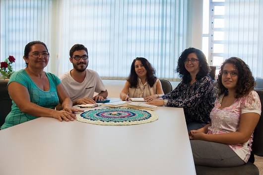 Grupo de pesquisadores do Locus sentado em volta da mesa (Foto: Ribamar Neto/UFC)